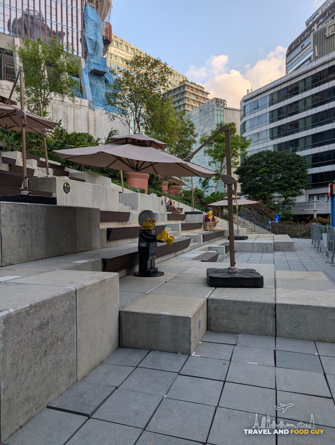 Concrete tiered seating with LEGO minifigures and umbrellas, part of a public play area near the Suntec area, Singapore