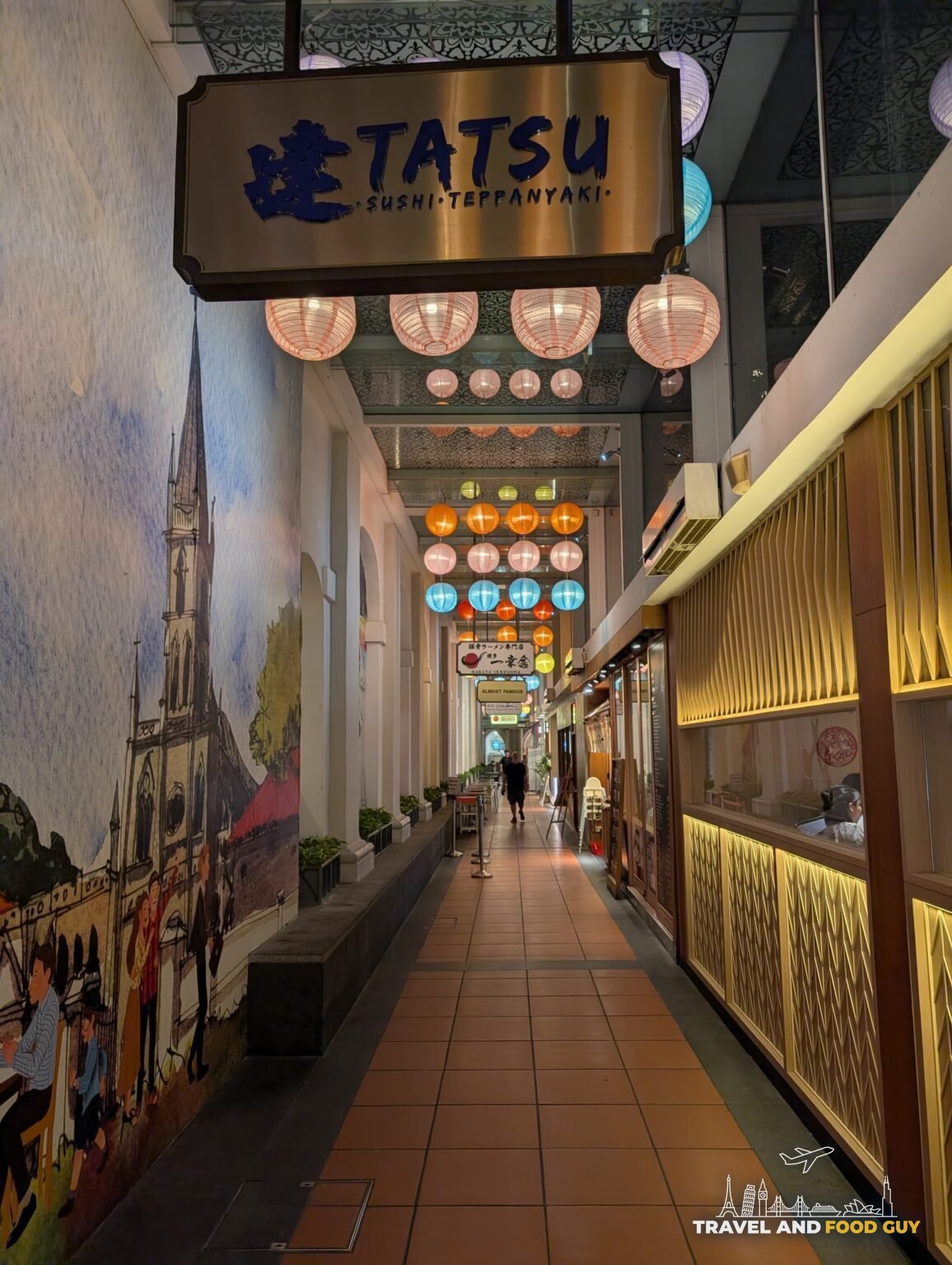 The Japanese arcade alley at Tatsu Sushi and Teppanyaki near Bugis, lined with paper lanterns and a chapel mural