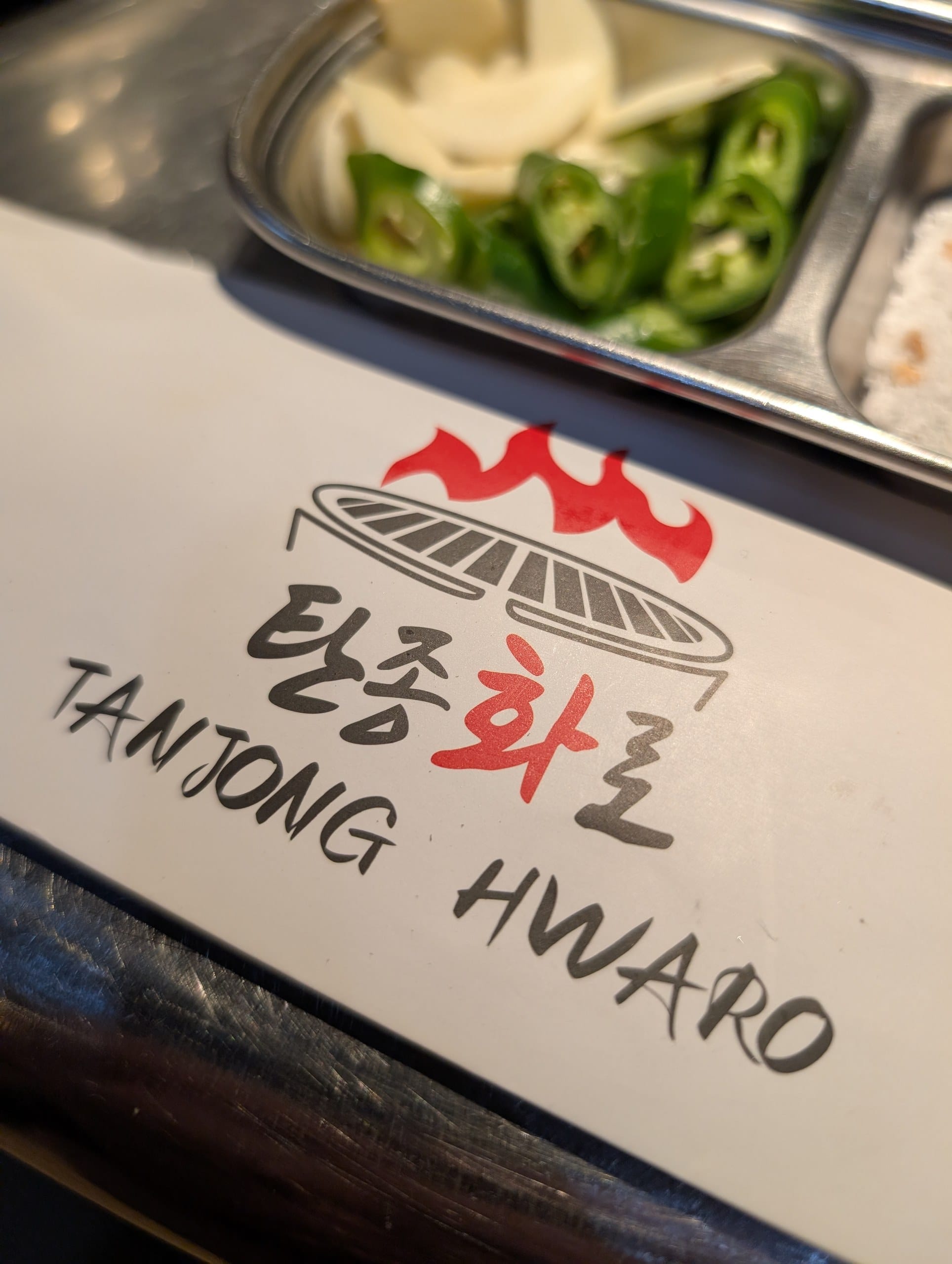 Tanjong Hwaro chopstick sleeve next to jalapenos and pickled radish