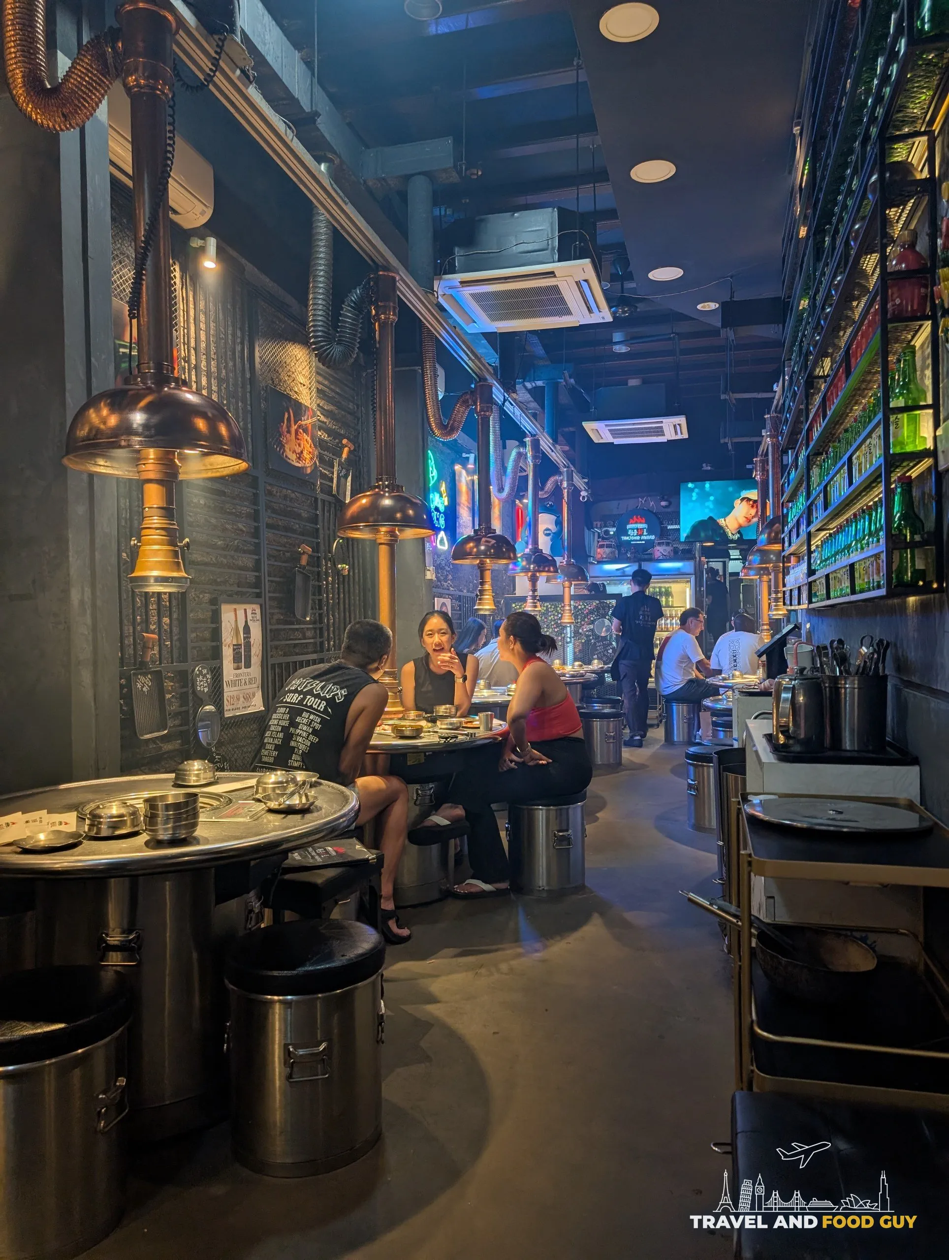 Tanjong Hwaro dining room, copper extractor hoods over drum tables