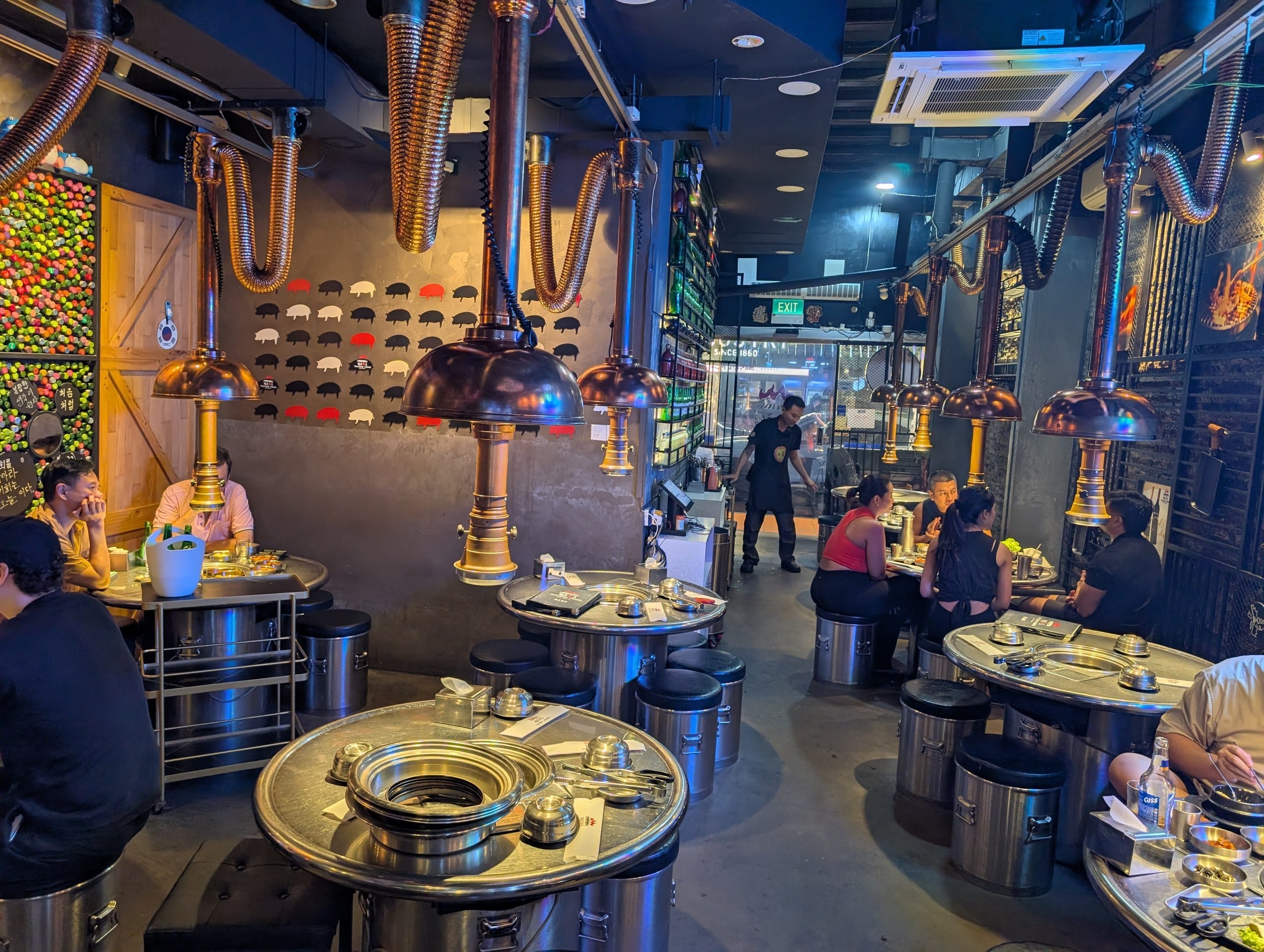 Tanjong Hwaro during service, copper hoods and staff working the room