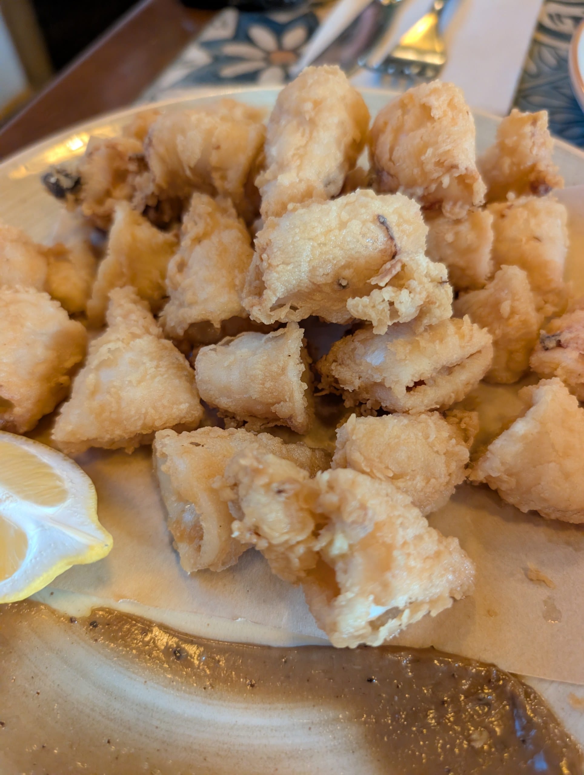 Chunky fried calamari with a wedge of lemon at Tapas San Miguel in Barcelona