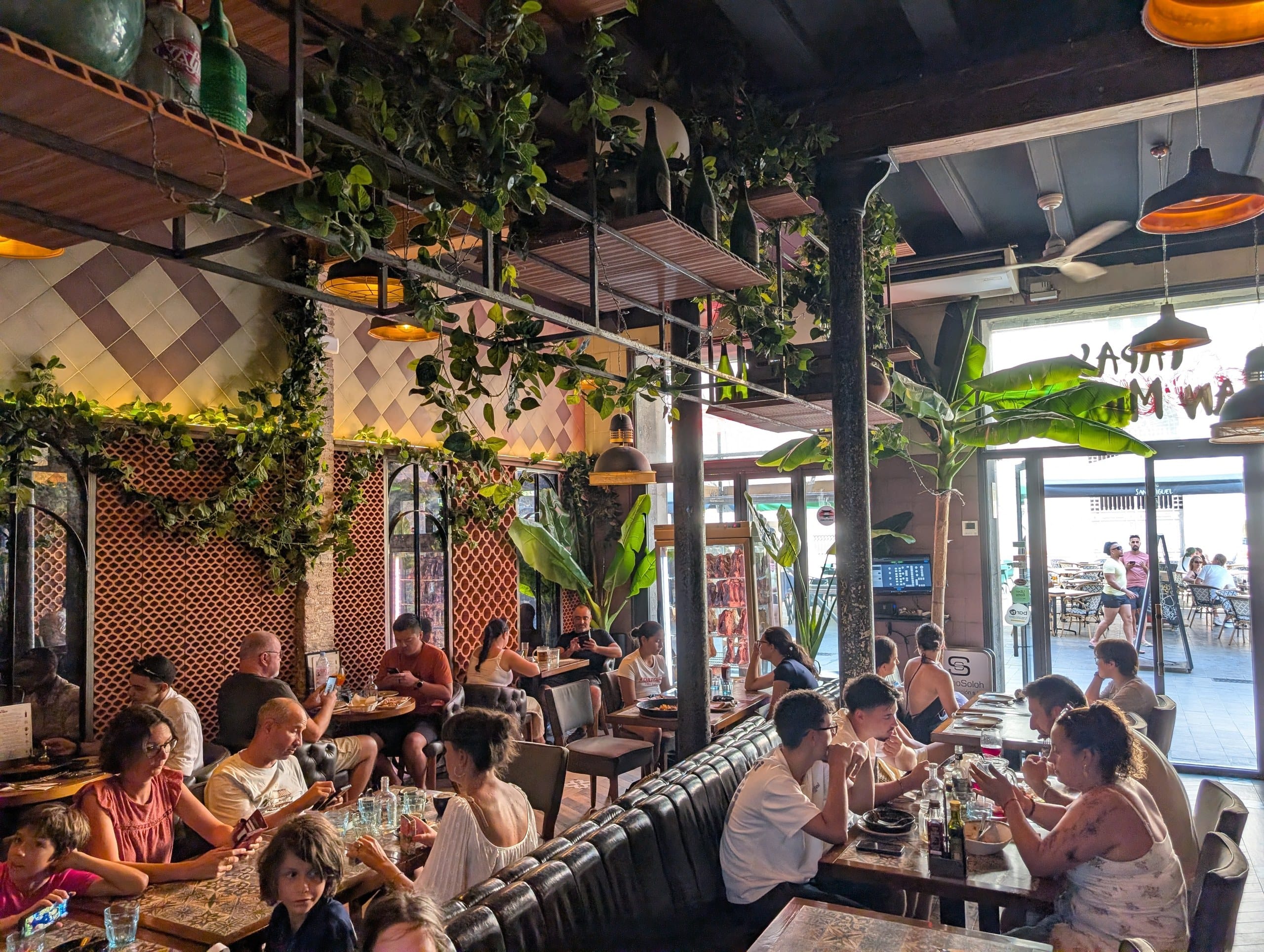Tiled walls and busy tables inside the dining room at Tapas San Miguel in Barcelona