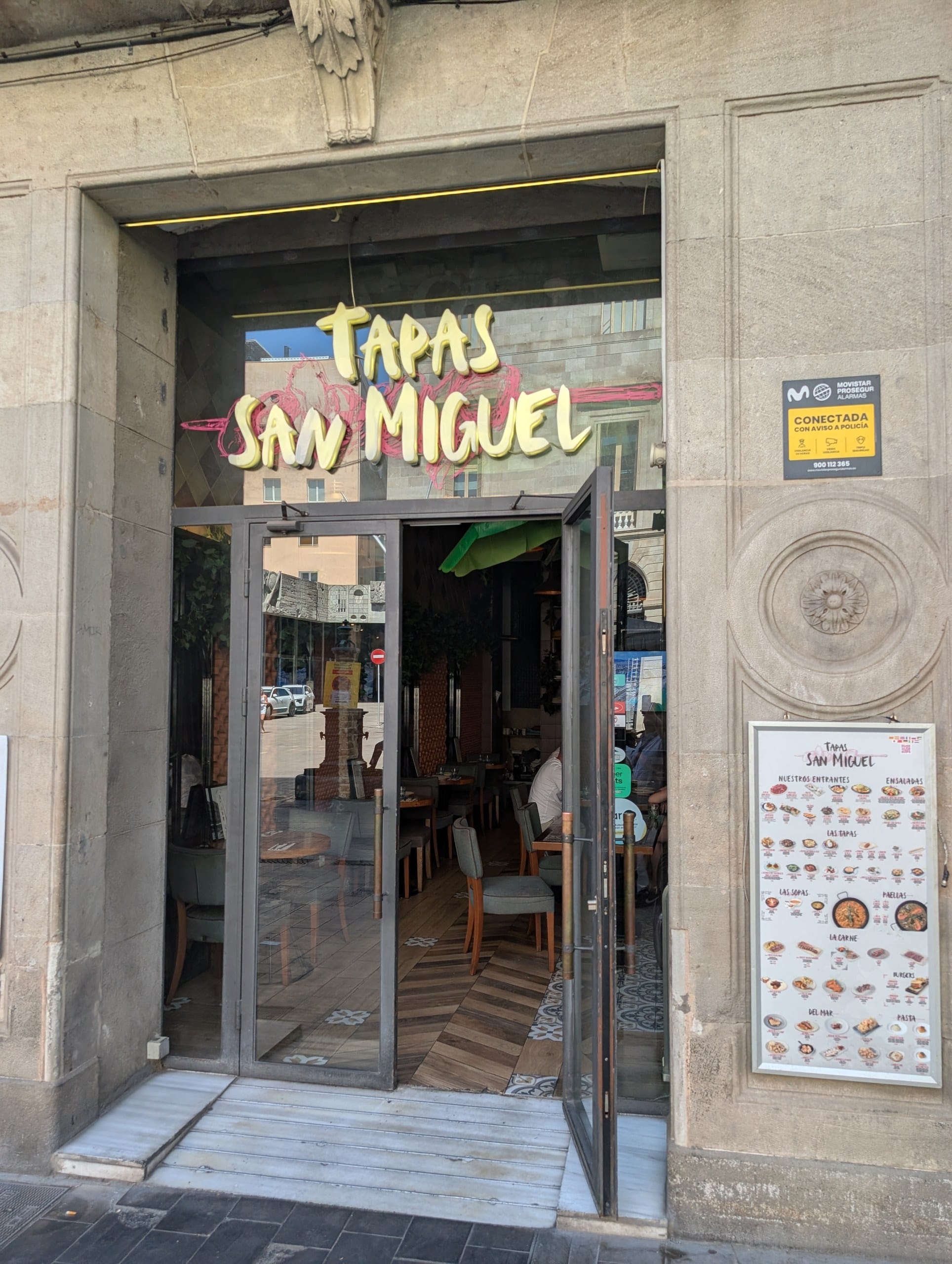 The doorway of Tapas San Miguel in Barcelona with its neon script sign above the entrance