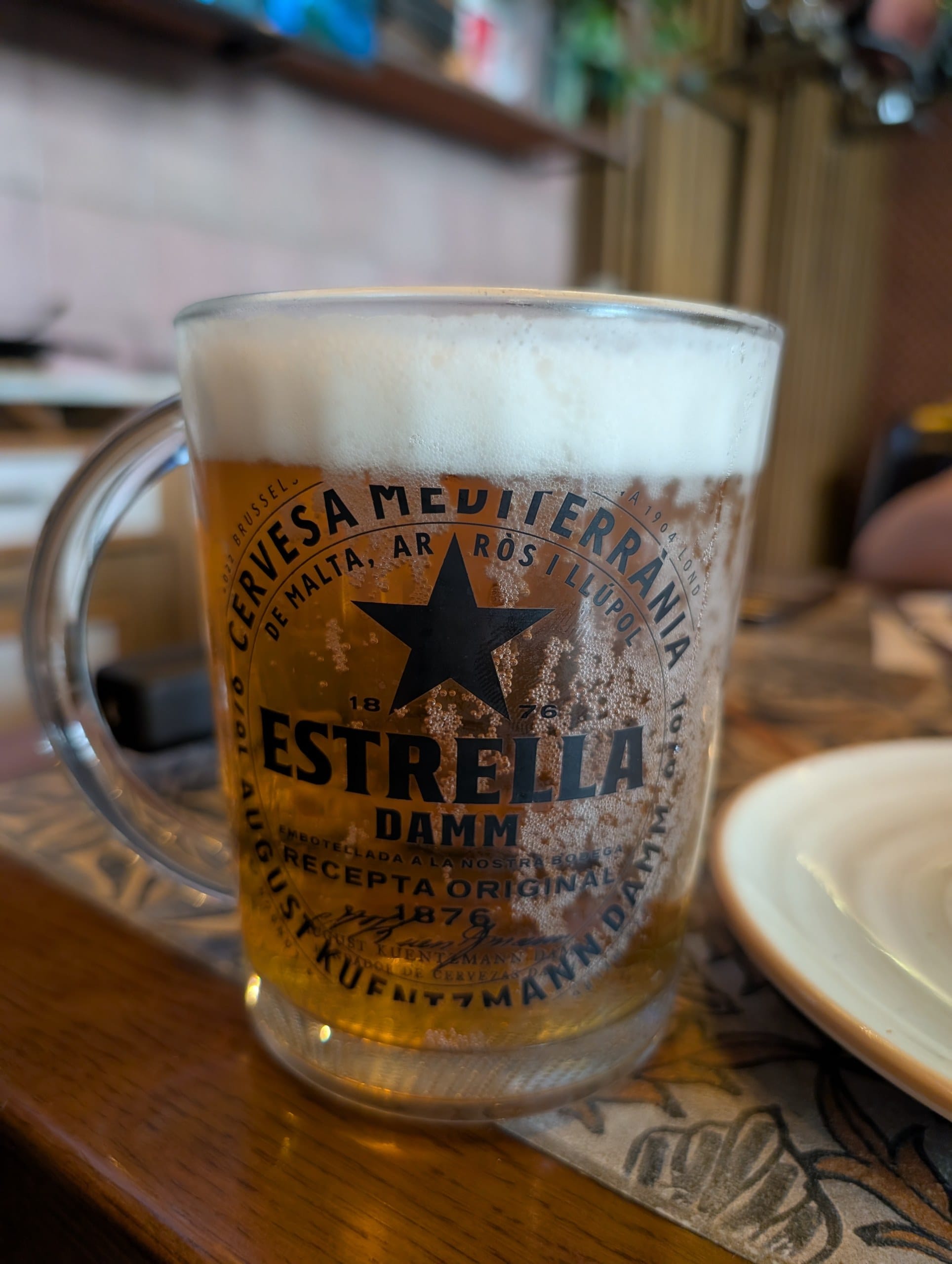 A jarra of Estrella Damm beer on the table at Tapas San Miguel in Barcelona