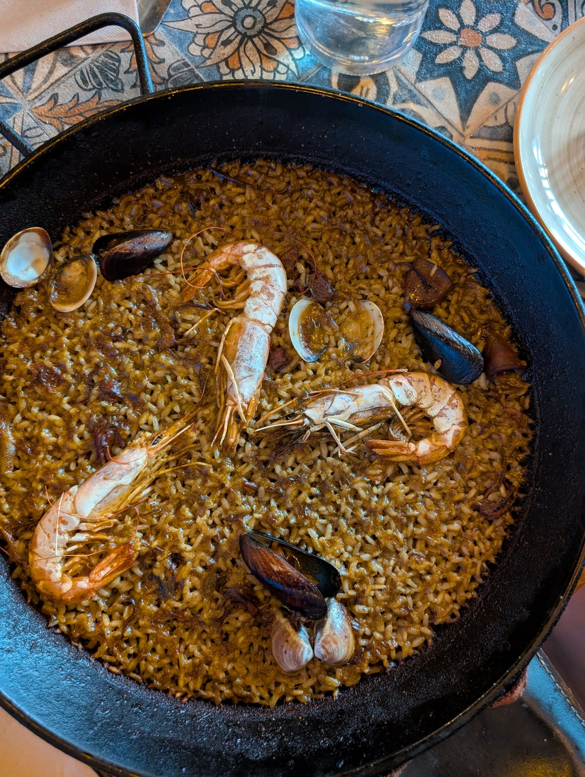 A steel pan of seafood paella with prawns, mussels and clams at Tapas San Miguel in Barcelona