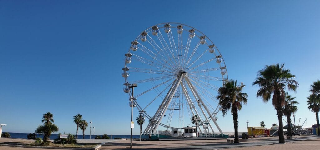 The 34 meter Ferris wheel on the Civitavecchia seafront against a clear blue sky