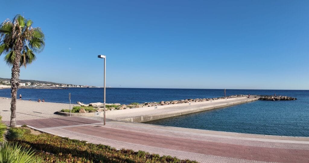 The beach, concrete groyne and rock breakwater on the Civitavecchia seafront