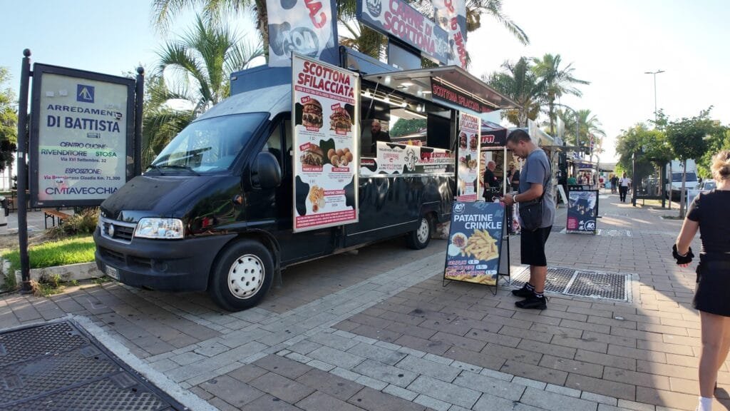 Black scottona sfilacciata food truck at the Civitavecchia street food festival with prices on the board
