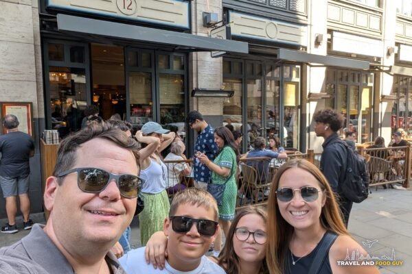 Alex, Vika, Josh and Emily taking a selfie outside Dishoom Covent Garden on Upper St. Martin's Lane.