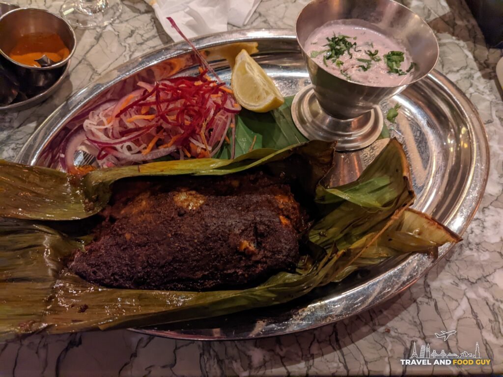 Tila Foi, sea bream griddled in a banana leaf, with raita, lemon and pickled onions at Dishoom Covent Garden.