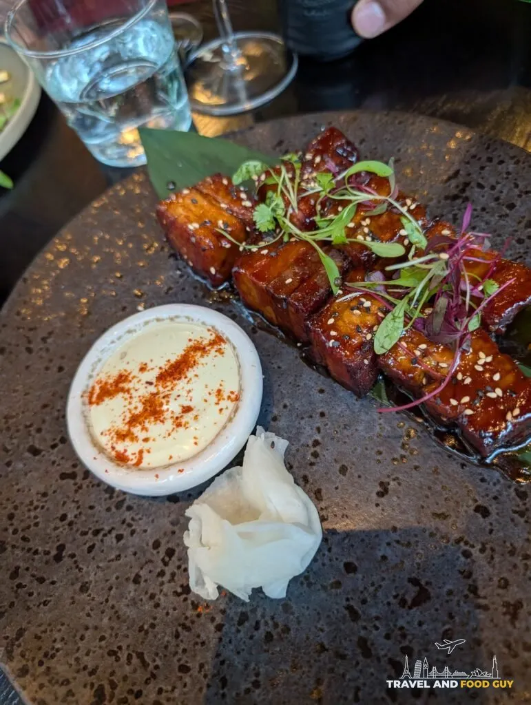 Glazed pork belly cubes with sesame, a creamy dip and pickled ginger at The Ivy Asia St Paul's.