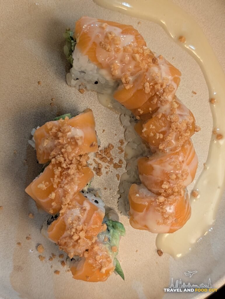 Kaido's Garlic Salmon roll topped with salmon, fried garlic and a creamy garlic ponzu.
