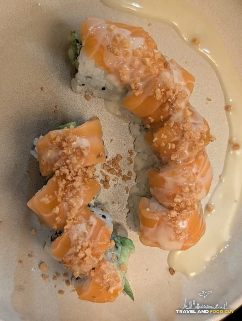 Kaido's Garlic Salmon roll topped with salmon, fried garlic and a creamy garlic ponzu.