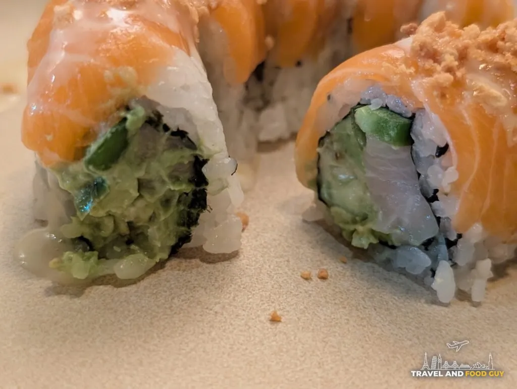 A cross section of Kaido's Garlic Salmon roll showing the filling.
