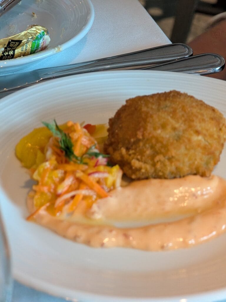 A crab cake starter in the main dining room on Legend of the Seas