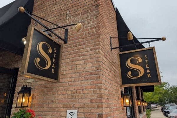 The hanging S Sophia Steak sign on the brick corner at 181 East Laurel Avenue in Lake Forest