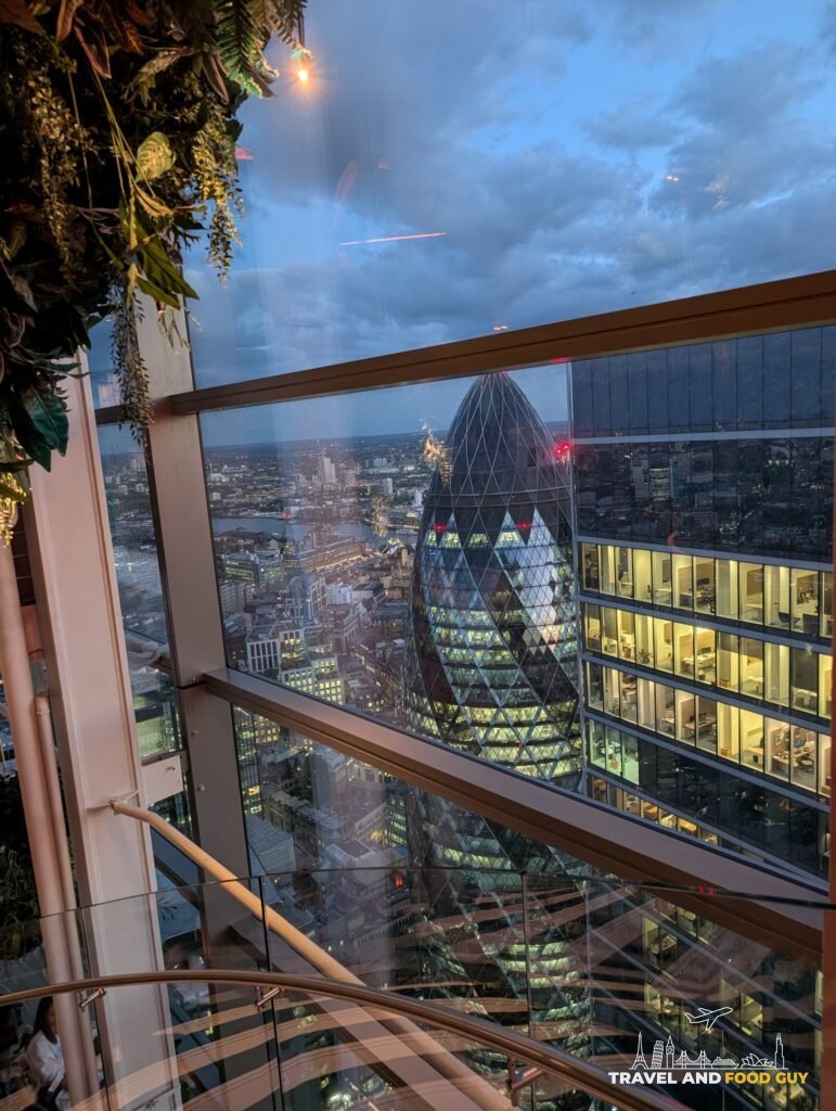 The Gherkin at dusk seen through the windows of SUSHISAMBA London.