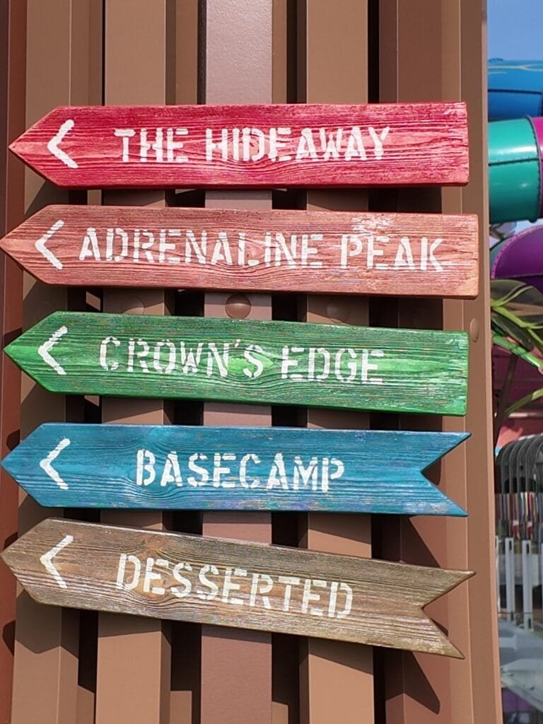 The Thrill Island signpost on Legend of the Seas with the Category 6 slides behind it