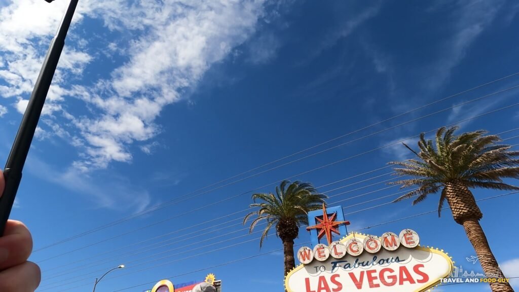 The Welcome to Fabulous Las Vegas sign under a blue sky with palm trees