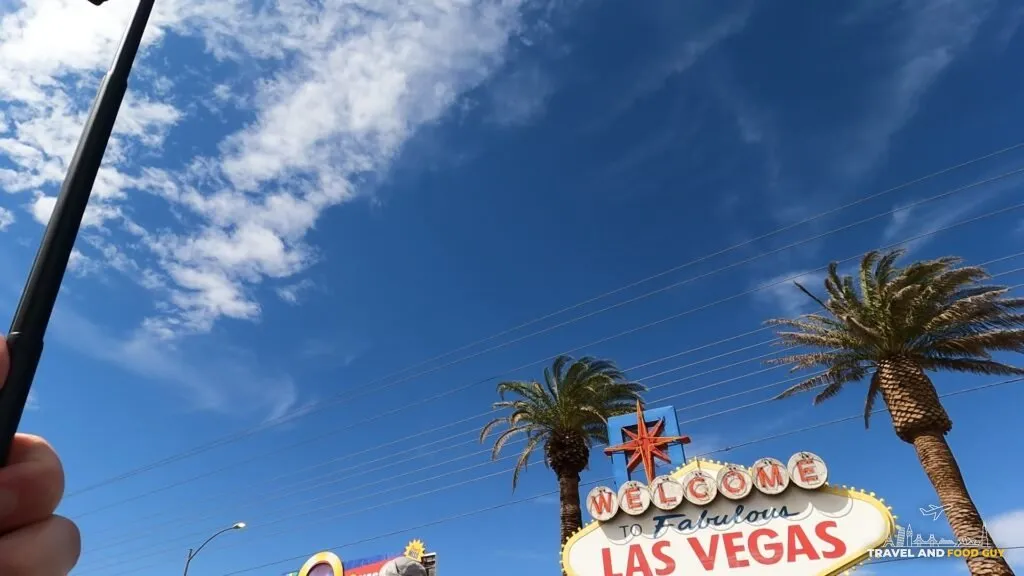 The Welcome to Fabulous Las Vegas sign under a blue sky with palm trees