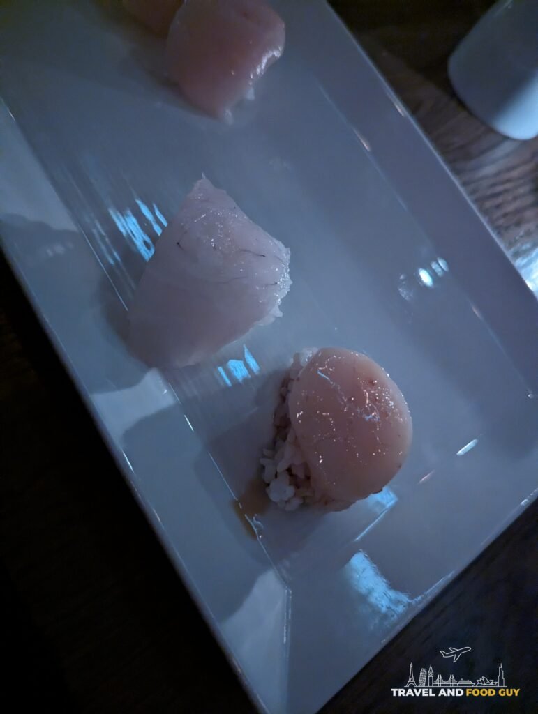Hirame, a Japanese halibut, served as nigiri with yuzu ponzu on a long white plate at SUGARFISH Beverly Hills.