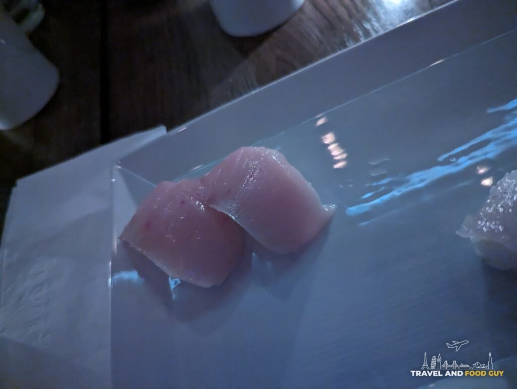 Two pieces of Japanese yellowtail nigiri on a white plate at SUGARFISH Beverly Hills.