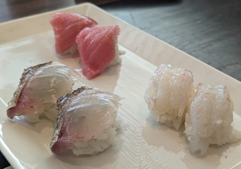 Tuna, sea bream and shrimp nigiri on a white plate at SUGARFISH Beverly Hills during a family lunch.