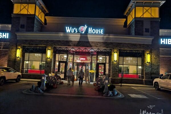 The front of Wu's House on Rand Road in Kildeer at night, lit up with lanterns, with the hibachi sign on one side.